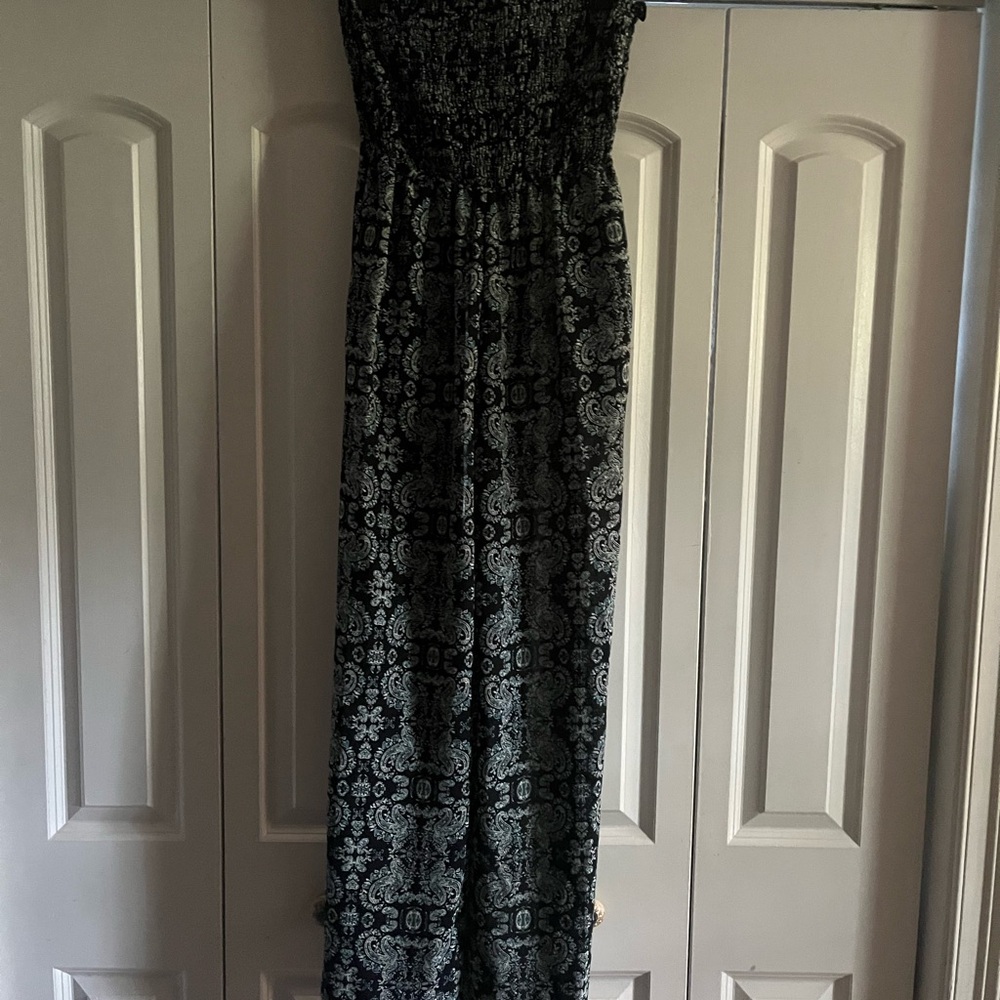 A strapless bodysuit with pockets that are wide leg never worn